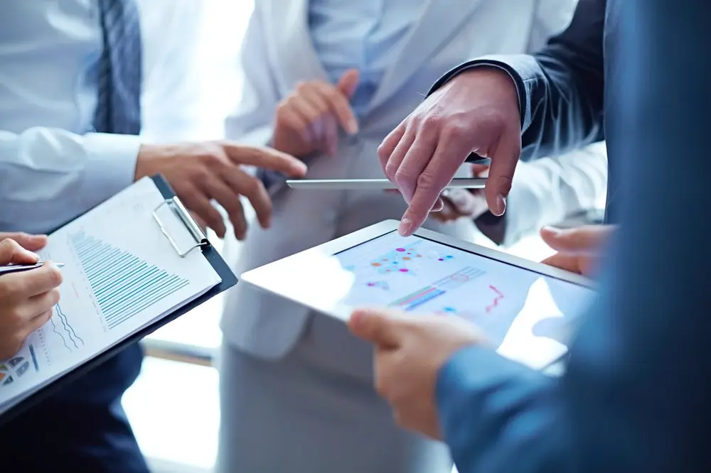 Consultants and a client team reviewing charts together